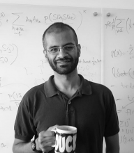 Man with beard smiles with a mug. in black and white